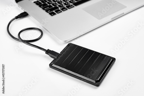 An external USB hard disk drive isolated on a white background. External Hdd drives and flash drives. External hard disk drive for connect to laptop, transfer or backup data between computer and HDD.