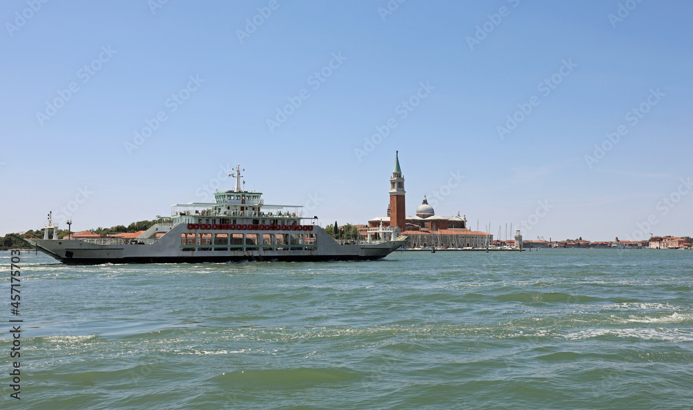 Venice lagoon with the large ferry boat for transporting the car between the Venetian islands in Italy