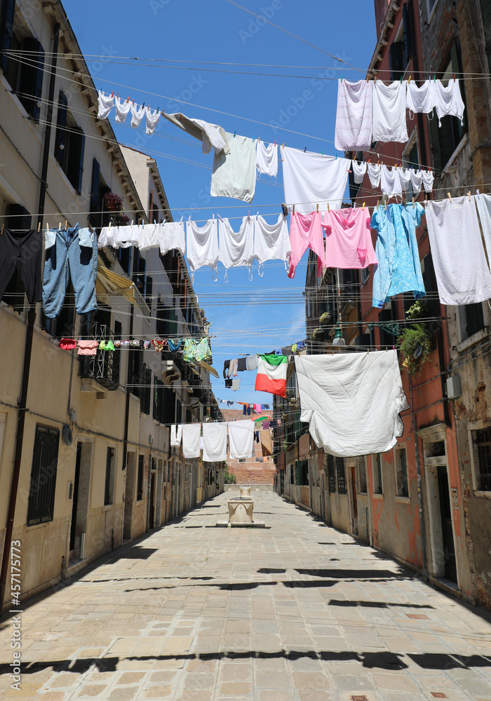 clothes hung out to dry in the sun in the narrow street of the Mediterranean city