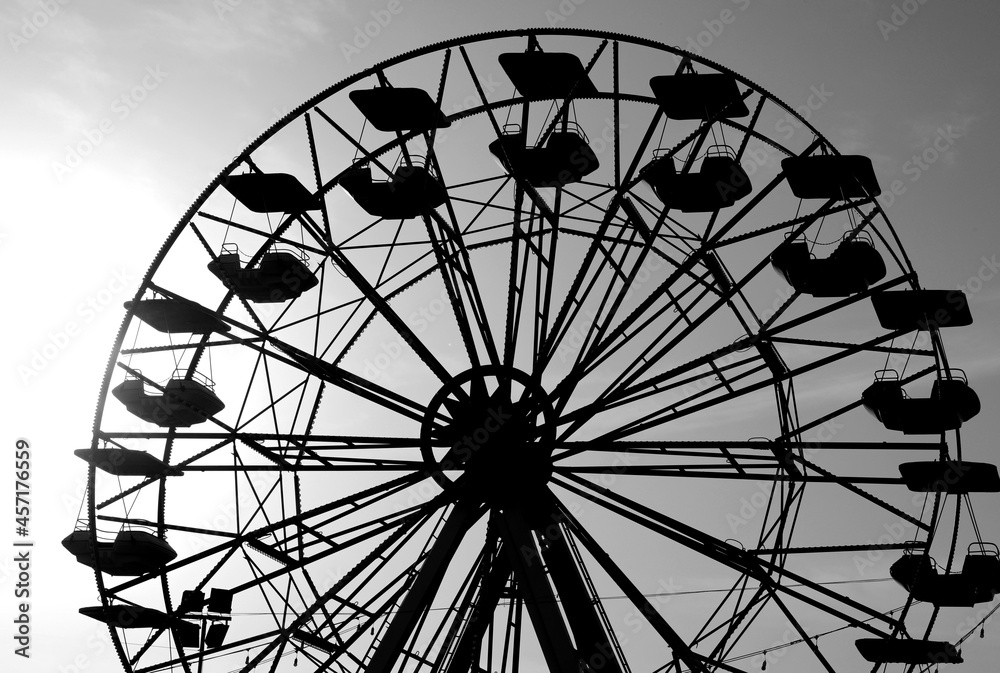 Ferris wheel of the amusement park with the seats that turn but without people Ferris wheel of the amusement park with the seats that turn but without people