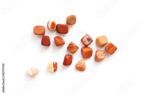 A scattering of beautiful smooth natural stones. Flint on a white background. photo