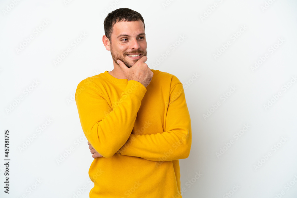 Young Brazilian man isolated on white background looking to the side and smiling Young Brazilian man isolated on white background looking to the side and smiling