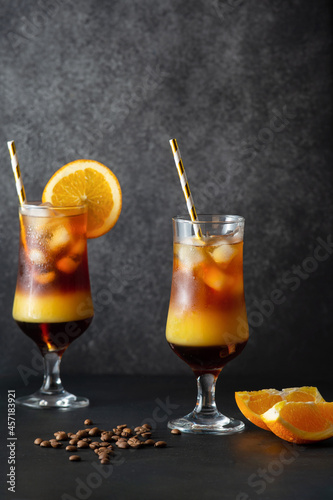 Two glasses of cold bumble coffee. Made with brewed coffee, orange juice and ice. Energy cocktail.