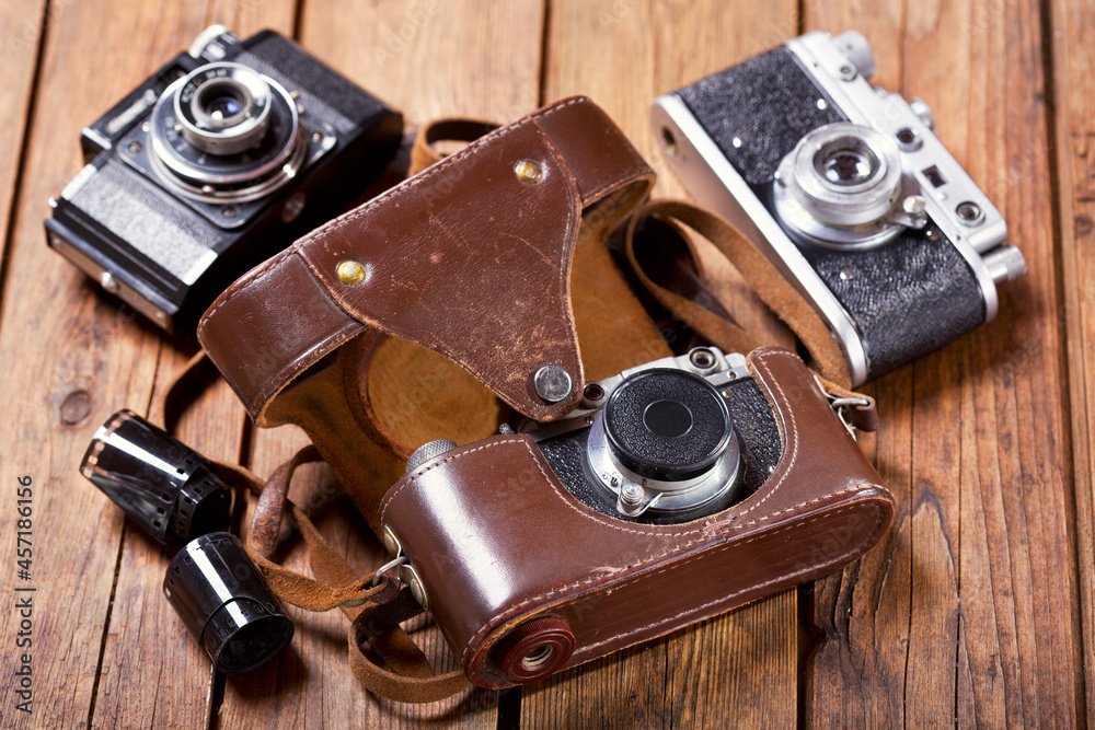 old retro cameras on wooden table old retro cameras on wooden table