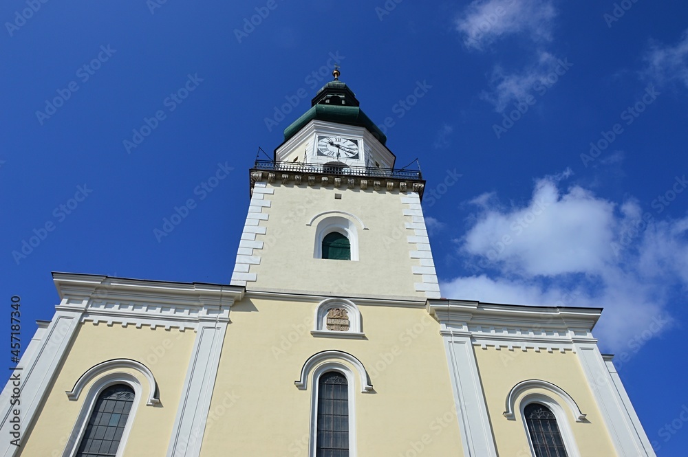 Tower and windows of Church of Saint Stephen The King in Modra, western Slovakia, build in renaissance and classicistic historicist style. Summer blue skies in background.