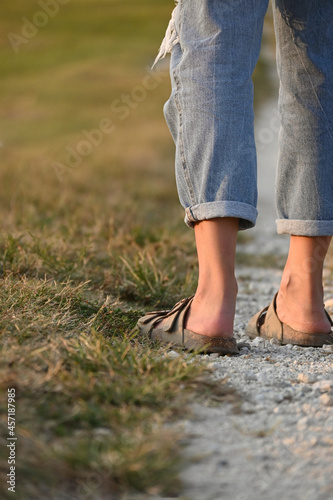 Close-up of woman's legs in the field, copy space.