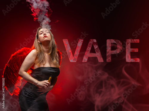 Vape pen in girl hand. She ...