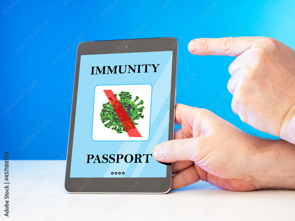 Foto de Covid 19 vaccination certificat in etablet. Man shows immunity
