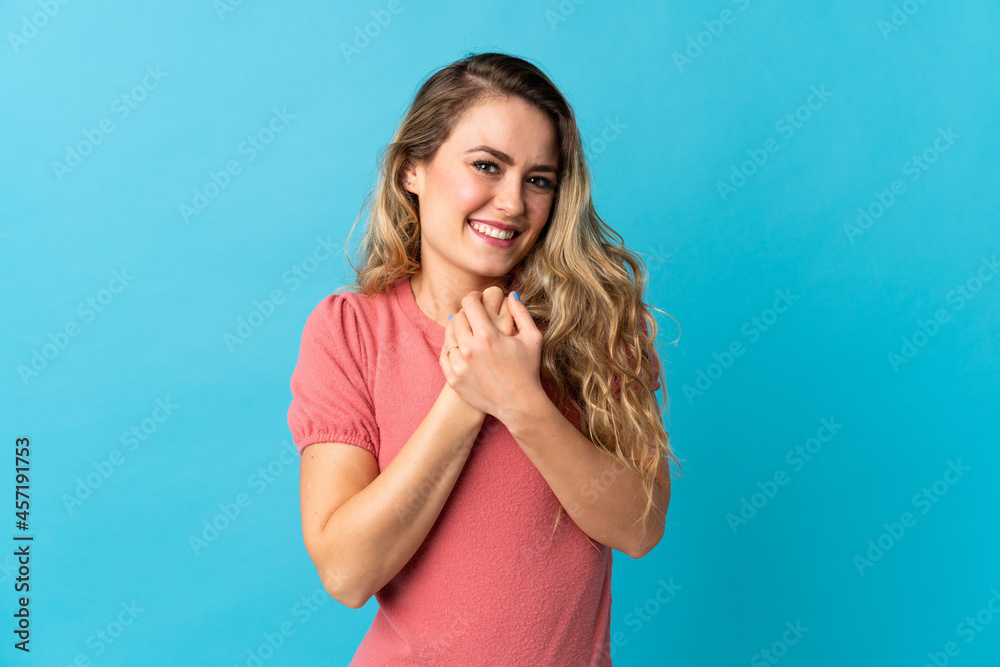 Young Brazilian woman isolated on blue background laughing Young Brazilian woman isolated on blue background laughing