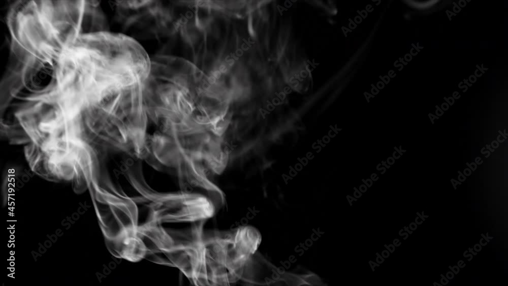 A jet of smoke in slow motion on dark background. Realistic atmospheric gray smoke. Abstract haze cloud. Mist effect and smoke stream effect in 4K. A jet of smoke in slow motion on dark background. Realistic atmospheric gray smoke. Abstract haze cloud. Mist effect and smoke stream effect in 4K.