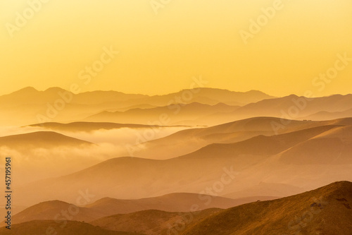 Yellow sunset in Mountain layers  fog  