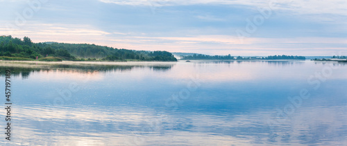 Beautiful panoramic landscape in the misty morning on the river. Svir river, Leningrad region, Russia.