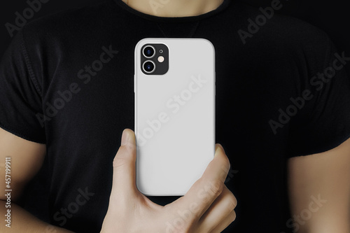 Man in black shows the phone in case mockup photo
