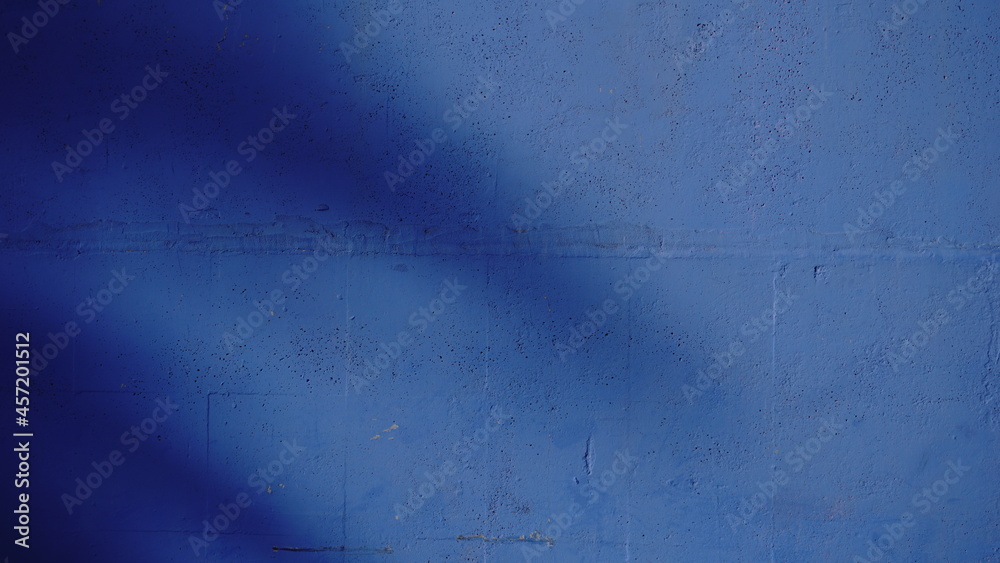 blue wall background with shadows