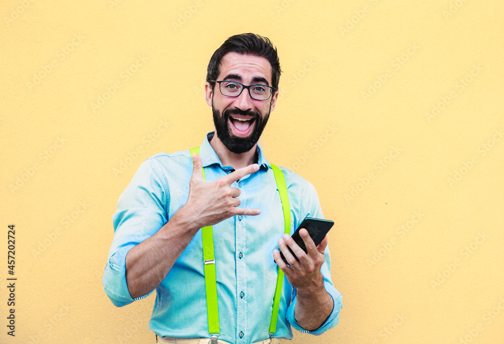 Elegant man with suspenders holds the mobile phone. Elegant man with suspenders holds the mobile phone.