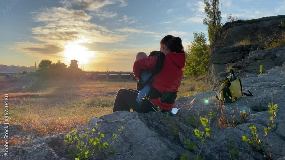 Mother with child outdoor traveling together walk in forest, adventure active healthy lifestyle, woman with baby carrier in mountains of Crimea, Russia. High quality 4k footage Mother with child outdoor traveling together walk in forest, adventure active healthy lifestyle, woman with baby carrier in mountains of Crimea, Russia. High quality 4k footage