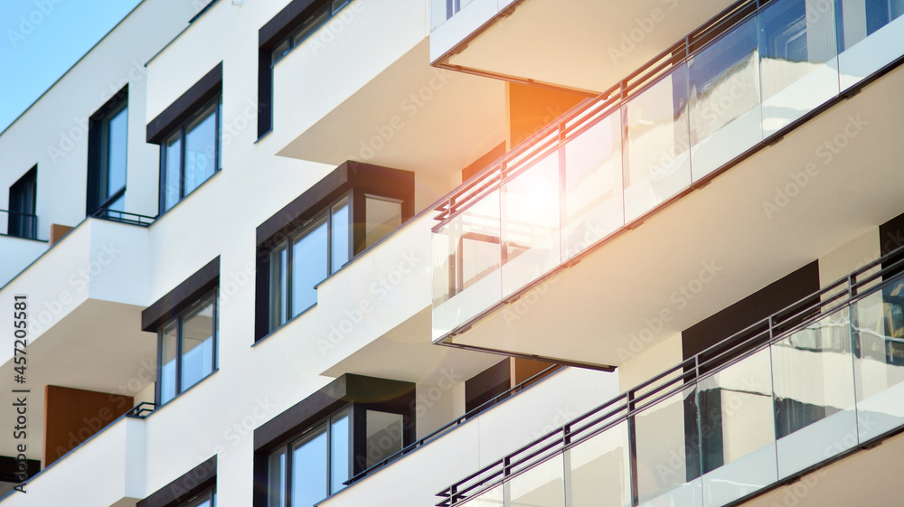 Modern apartment building on a sunny day. Architectural details and facade of a modern apartment building. Modern apartment building on a sunny day. Architectural details and facade of a modern apartment building.