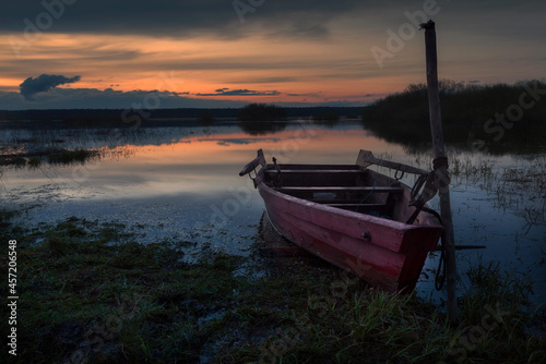 A moored boat at sunset lake, Russian North-West