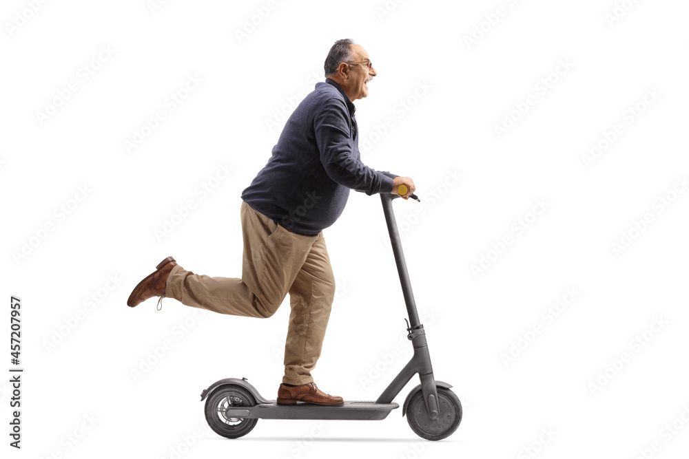 Cheerful mature man riding an electric scooter Cheerful mature man riding an electric scooter