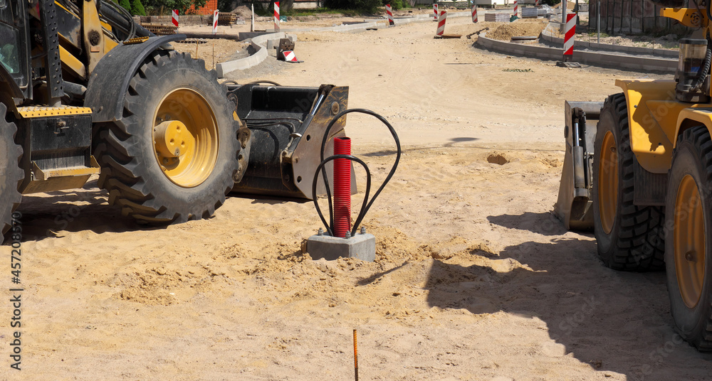 Two tractors, foundation for a lighting pole, road construction in the city. Two tractors, foundation for a lighting pole, road construction in the city.