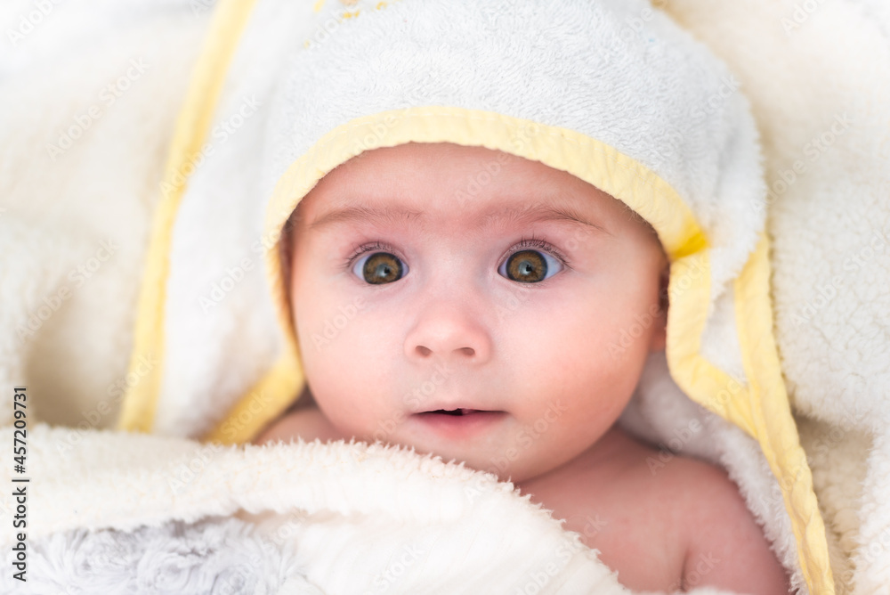 Cute baby girl after bath wrapped in towel. Hygiene and health care concept of new born Cute baby girl after bath wrapped in towel. Hygiene and health care concept of new born