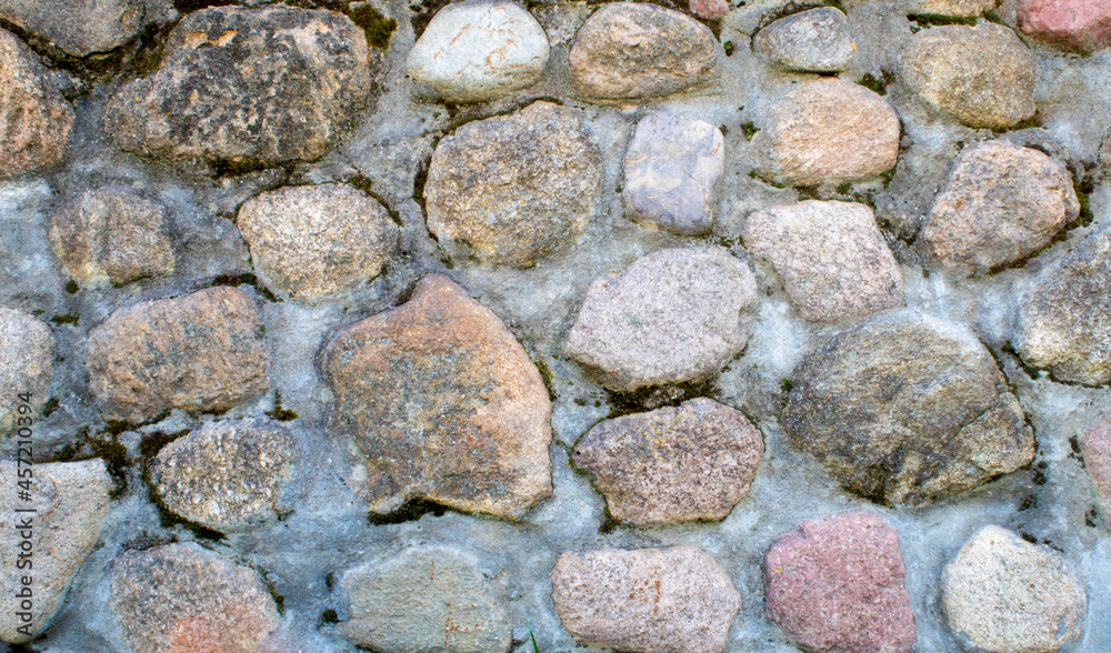 Stone wall texture. Mosaic rocks decorative interior wall background. Masonry wall of old stones