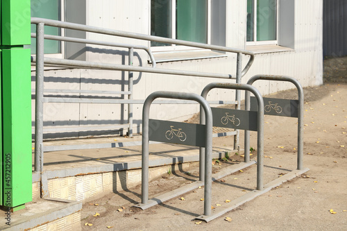 Empty bicycle parking near store with slope ramp for moving people with disabilities