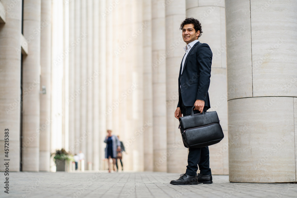 A confident businessman manager goes to work. An economist in a business suit. The lawyer takes a break during working hours.