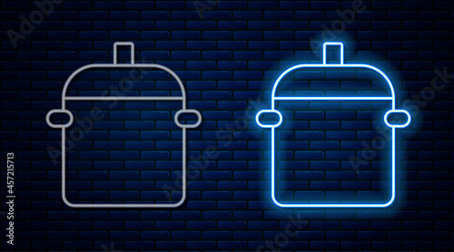 Glowing neon line Cooking pot icon isolated on brick wall background. Boil or stew food symbol. Vector
