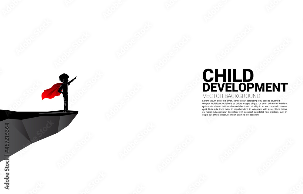 Silhouette of boy in superhero suit point from the cliff. Concept of education start and future of children.