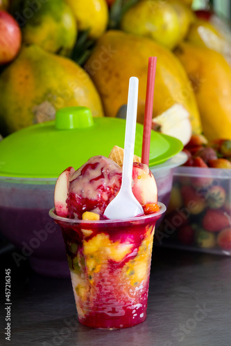 Preparation of a traditional sweet water ice with fruits called cholado in the city of Cali in Colombia