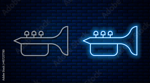 Glowing neon line Trumpet icon isolated on brick wall background. Musical instrument trumpet. Vector