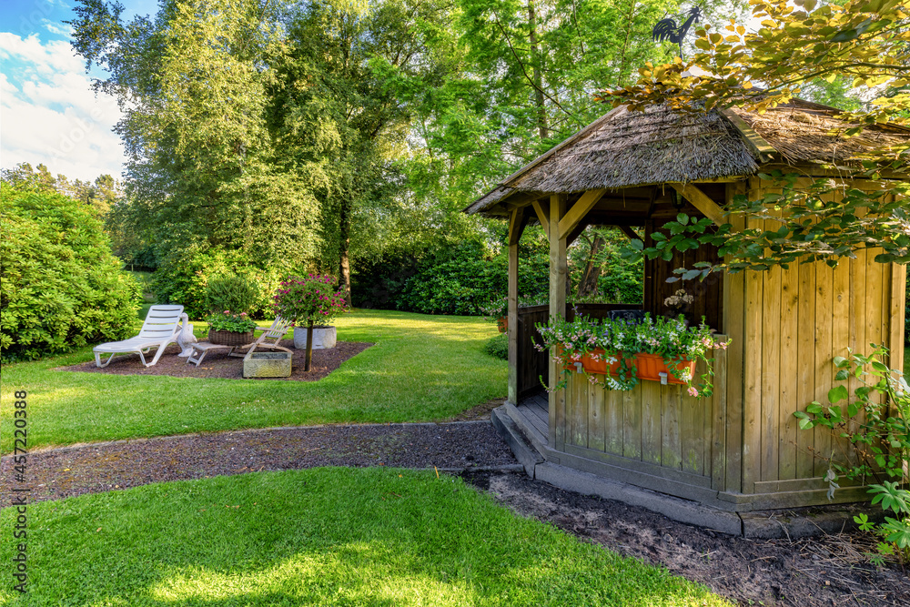 Dreamlike garden design with Pavillion, deck chair, grass, paths, flowers and other plants Dreamlike garden design with Pavillion, deck chair, grass, paths, flowers and other plants