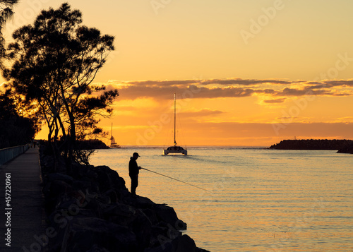 Fishing and catamaran on the river at sunrise  photo