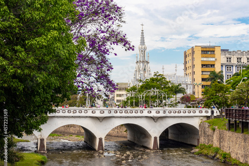 Beautiful church with a spring view, colorful trees and a river running through the city photo