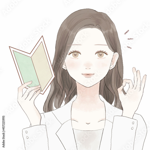 初心者マークを持つ、OKサインを出す女性医師