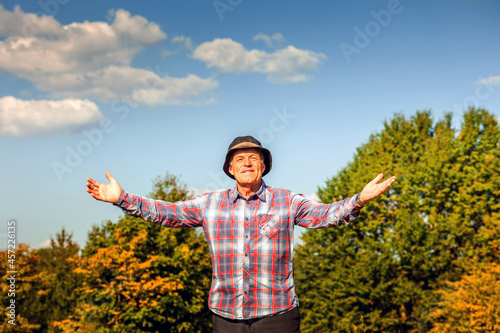 The older man is looking forward to beautiful nature and a healthy life photo