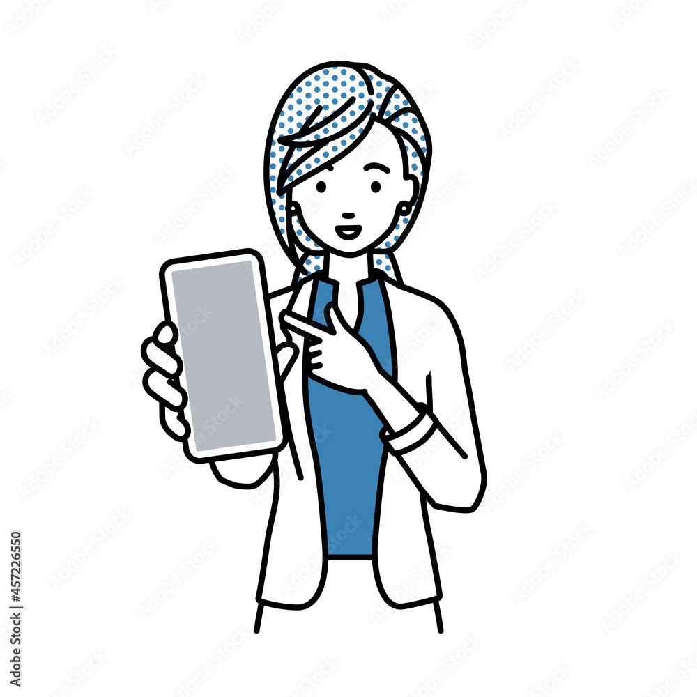 立ってスマートフォンを指差してこちらに向けて見せているジャケットの女性 立ってスマートフォンを指差してこちらに向けて見せているジャケットの女性