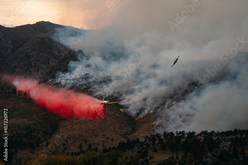 A spotter plane guides in a Slurry Bomber to help contain the Cal-Wood Fire in Boulder, Colorado 2020