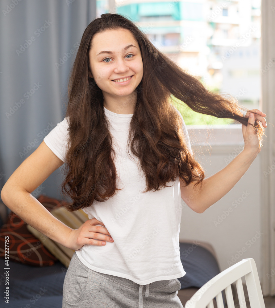 Happy young attractive woman posing at modern home apartment