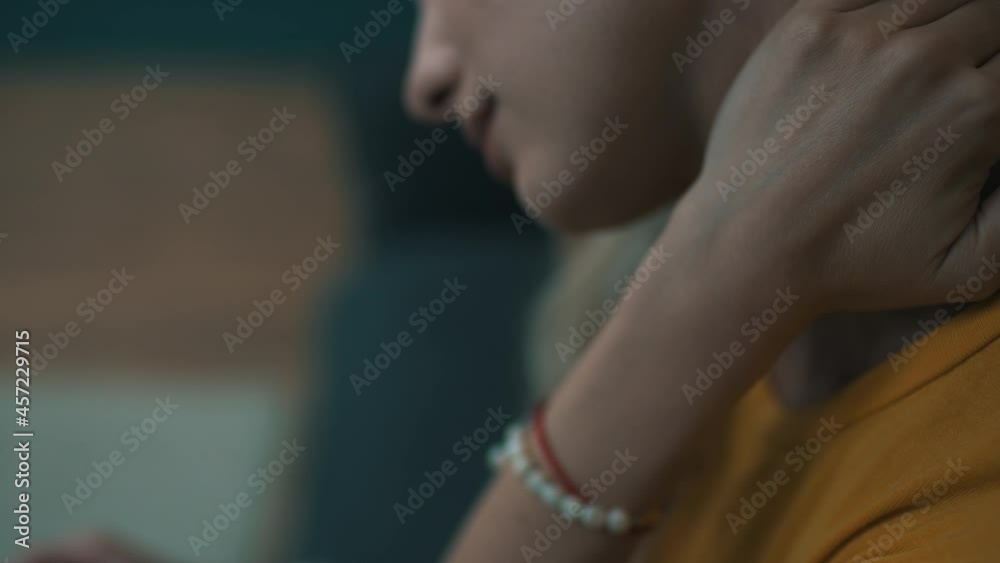 woman kneads neck while using smartphone woman kneads neck while using smartphone