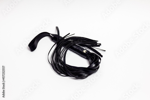 Leather whip on white background