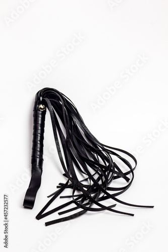 Leather whip on white background