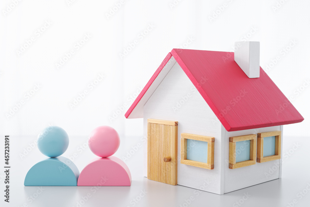New house and life image. Miniature house and couple.