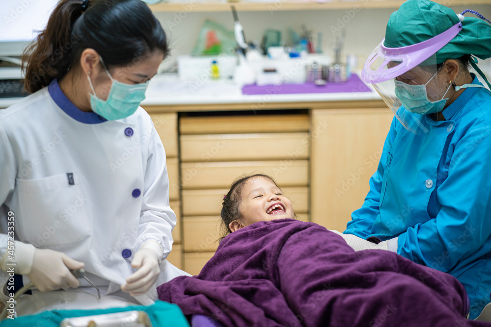 Asian dentist check up little Asian girl teeth healthy in Dental's office. Dental care, Medical care, Lifestyle, Dental clinic or dental procedure concepts Asian dentist check up little Asian girl teeth healthy in Dental's office. Dental care, Medical care, Lifestyle, Dental clinic or dental procedure concepts