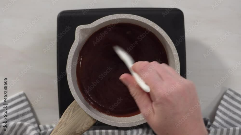 Step by step. Flat lay. Preparing chocolate frosting in a small saucepan over an electric pan. Step by step. Flat lay. Preparing chocolate frosting in a small saucepan over an electric pan.