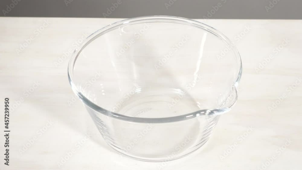 Step by step. Mixing ingredients in a glass mixing bowl to bake chocolate bundt cake with chocolate frosting. Step by step. Mixing ingredients in a glass mixing bowl to bake chocolate bundt cake with chocolate frosting.