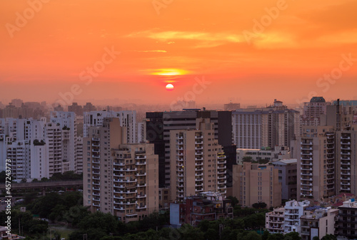 Beautiful sunset in Gurgaon Haryana India skyline during Covid 19 pandemic on September 04 2021.Exterior view of urban  modern cityscape with residential apartments in Delhi NCR s posh locality.