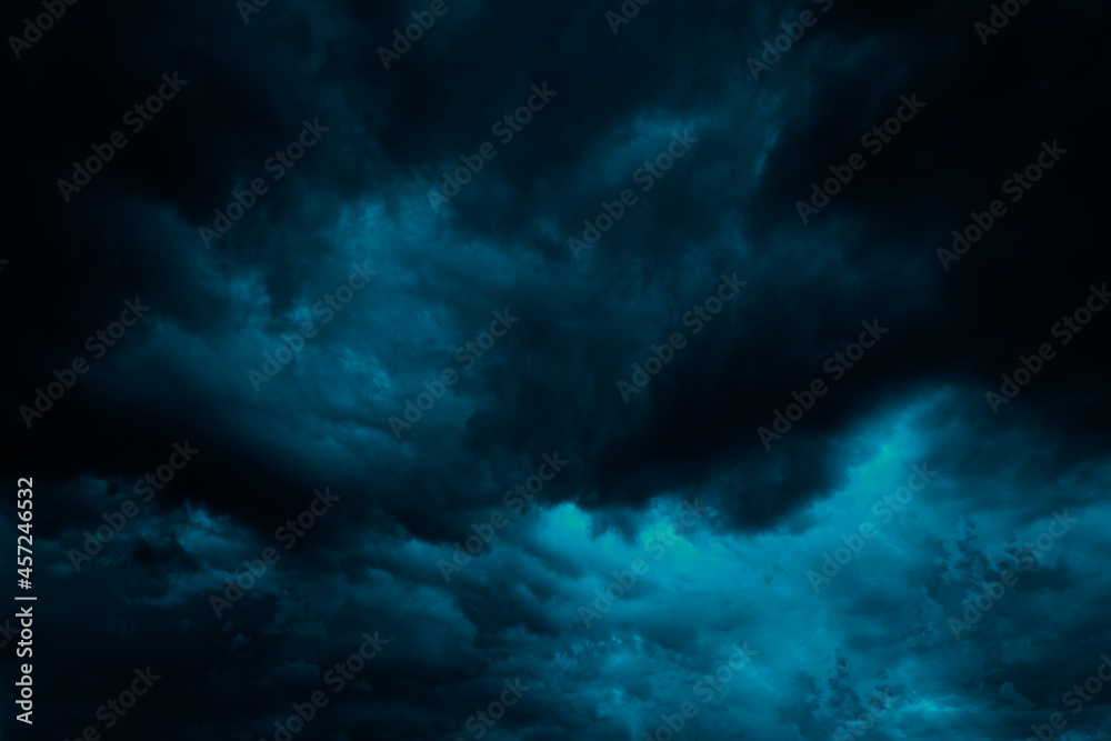 Dramatic blue green sky. Gloomy heavy thunderclouds. Dark teal sky background with copy space for design.