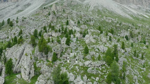 Aerial of mountain cable car climbing between rocky slopes, Dolomites